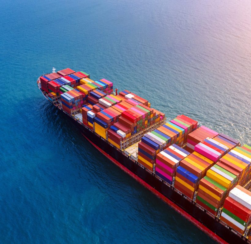 Aerial view of container cargo ship in sea.